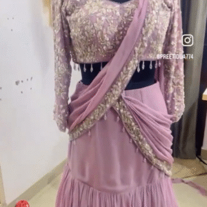 The dress in the image is an elegant traditional Indian outfit, likely a lehenga choli with a modern twist. Here are some details
